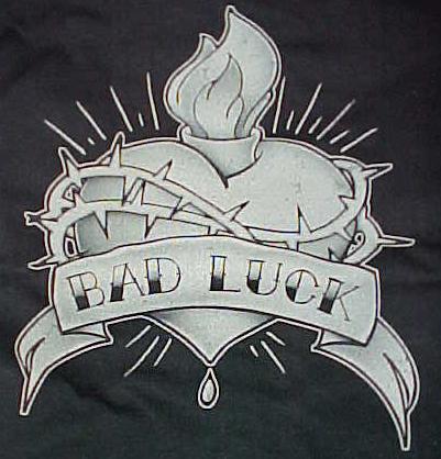 Retro kustom tattoo t-shirt featuring a skull tearing a black heart apart,